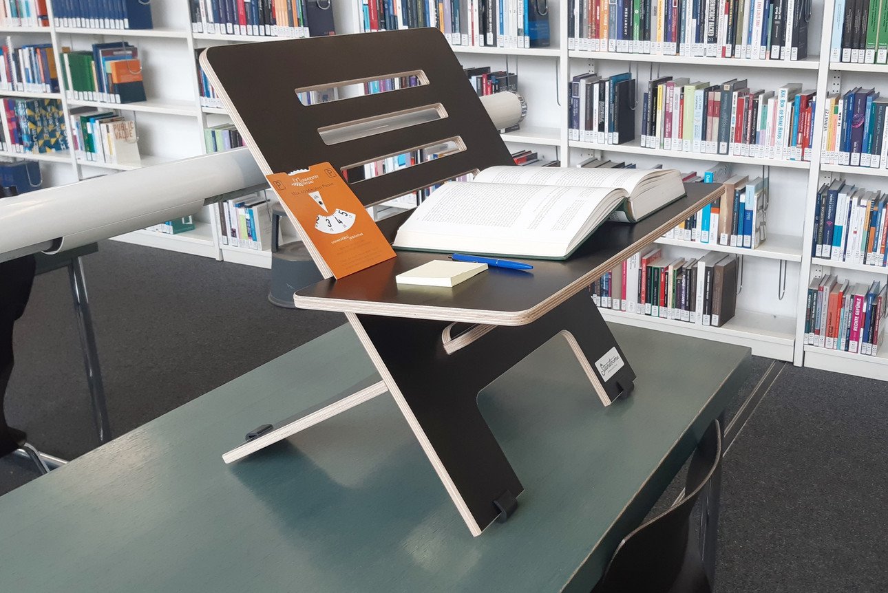 Standing desk converter that can be used to transform any reading room seat into a standing workstation