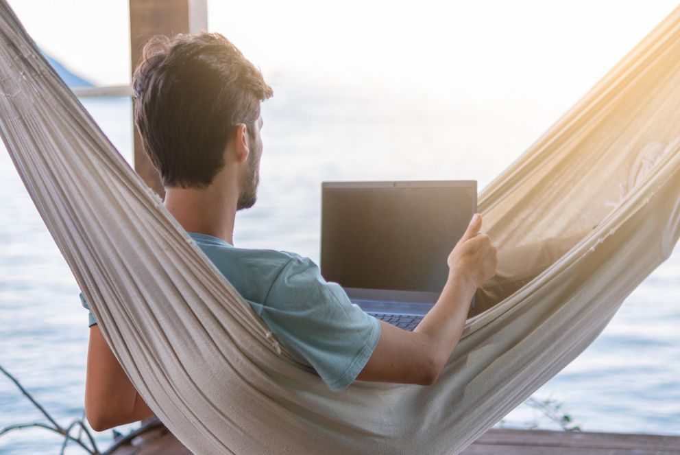 Person with laptop in hammock